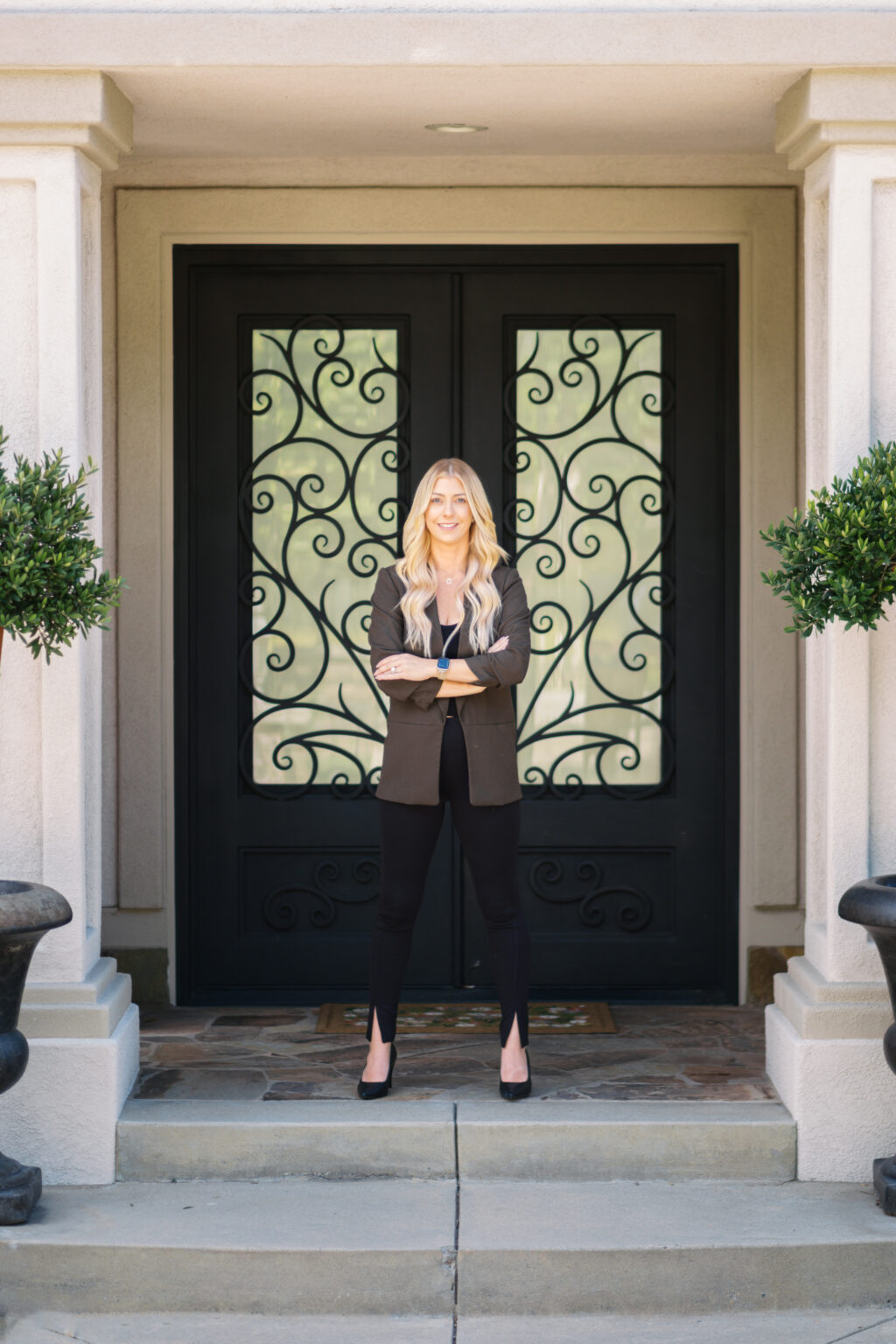 Sumer Mirkovich, trust and estate real estate advisor, at the door of a foothill estate