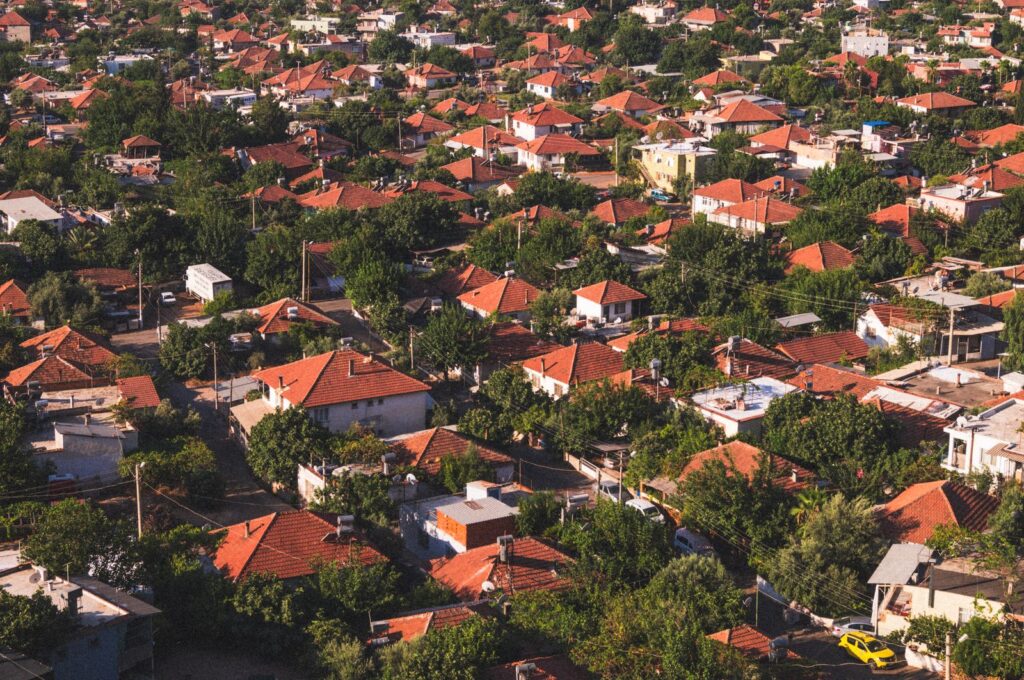 Foothill Luxury Market Snapshot Aerial view of red-tile rooftops among trees