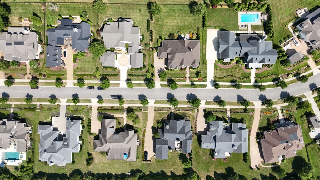 Aerial view of upscale San Marino-style homes on large landscaped lots