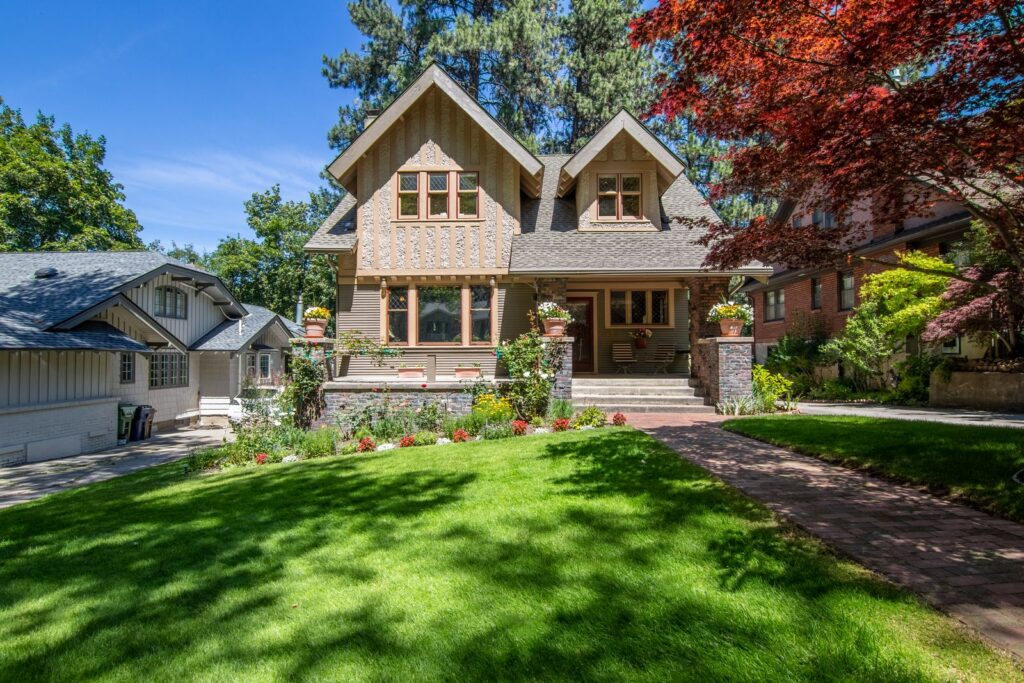 The Trust Sale Guide Stately craftsman home with manicured lawn